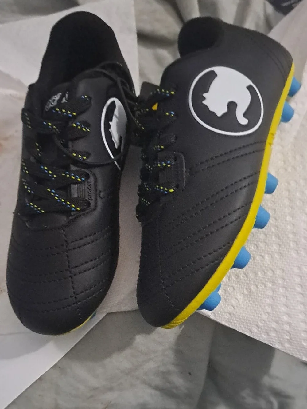 Puma Kids Black Soccer Cleats with Yellow Sole and Blue Studs